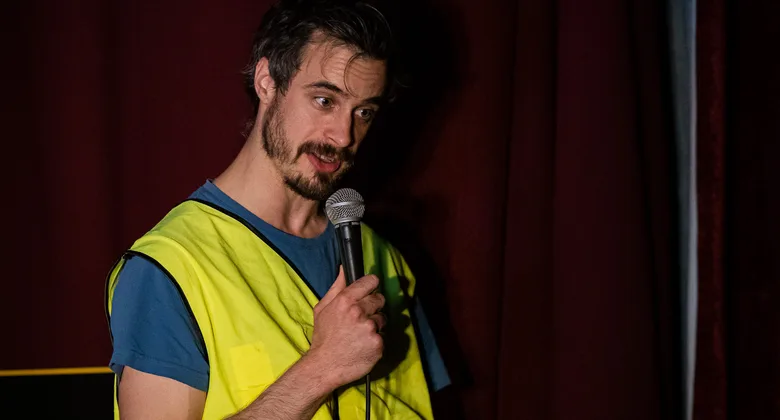 A comedian performing at Soho Comedy Factory's Blue Posts venue on Berwick Street