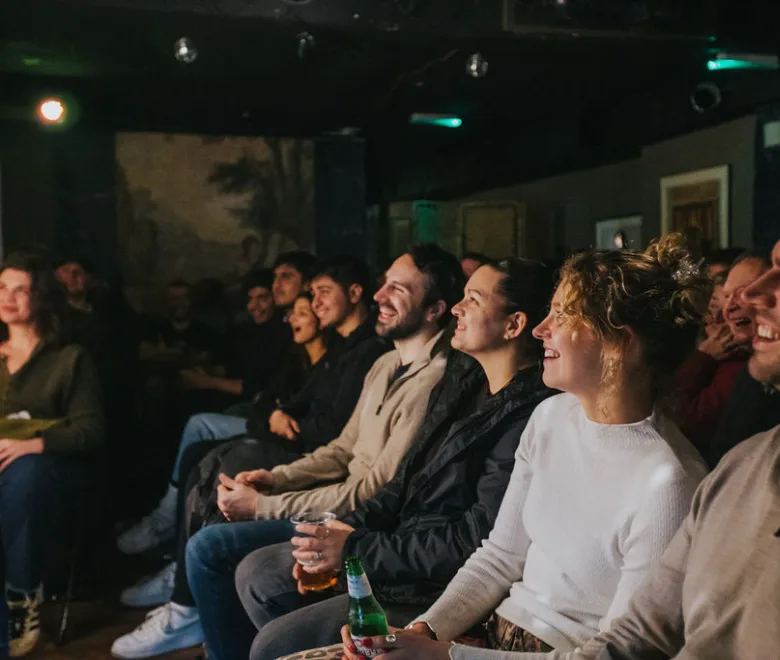 An audience laughing at a Soho Comedy Factory show